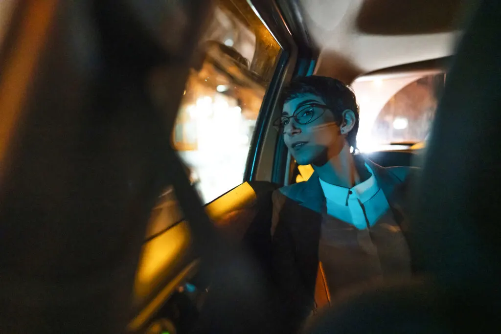 young woman in back of taxi