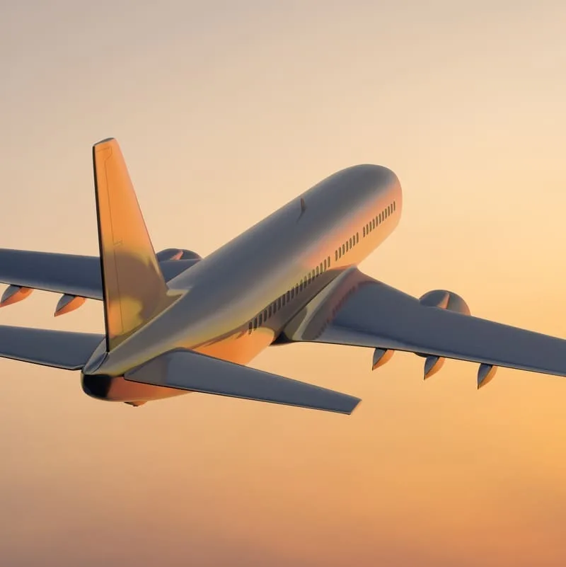 Plane flying in sunset