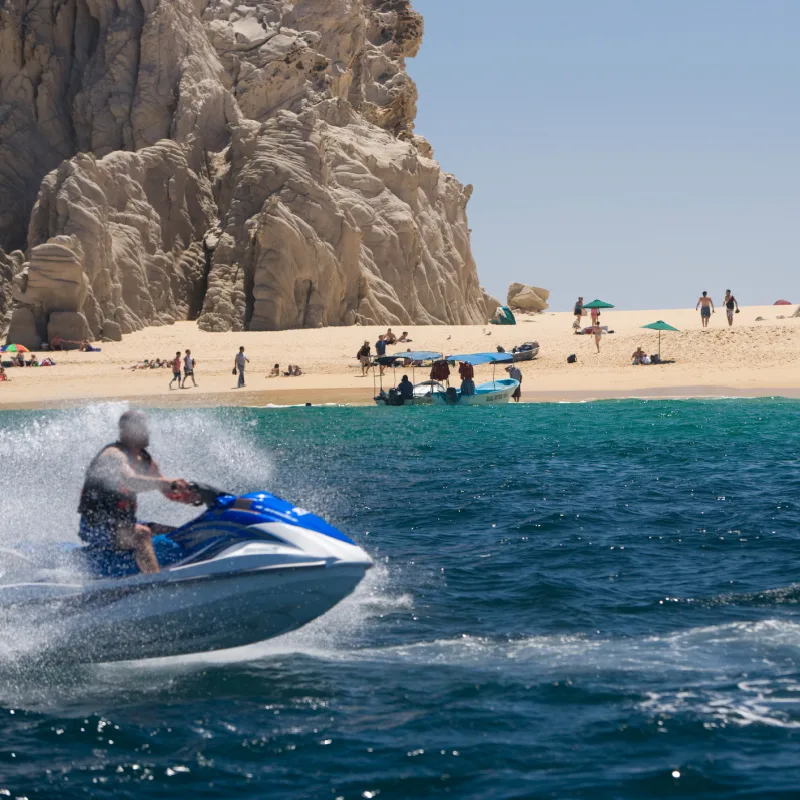 tourists on jet ski and beach