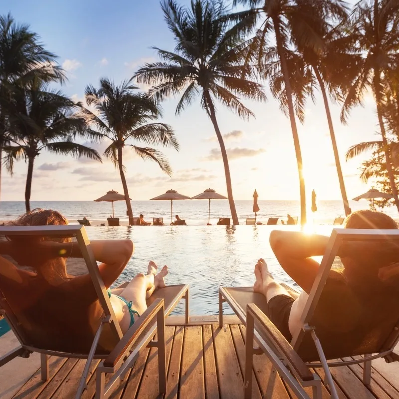 People Lounging in Chairs at a Beach Club