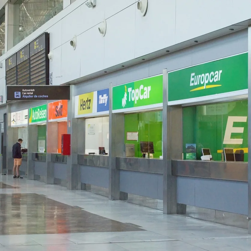 Rental car offices counter inside the airport terminal, empty in soon morning hours, International airport Reina Sofia, Tenerife South