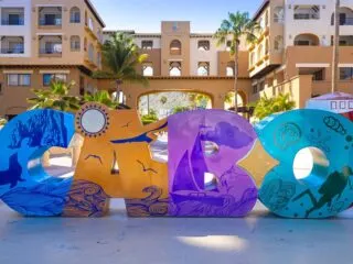 Los Cabos colorful letters in Cabo San Lucas marina a departure point for cruises, marlin fishing and lancha boats to El Arco Arch and beaches