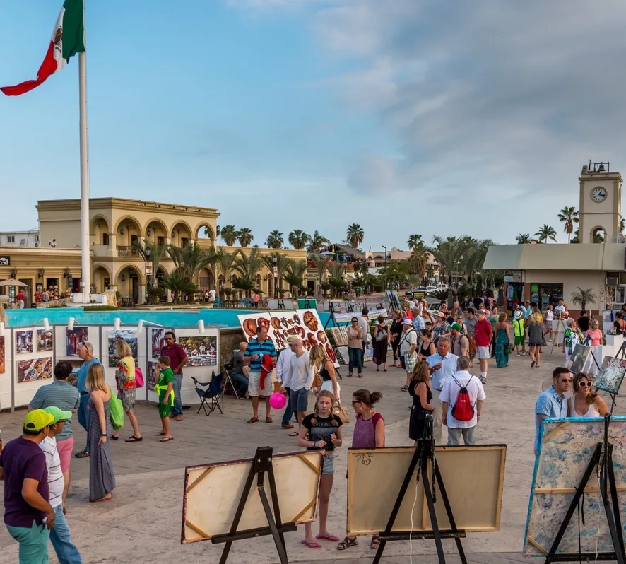 People milling around the town square looking at art in San Jose del Cabo, Mexico.