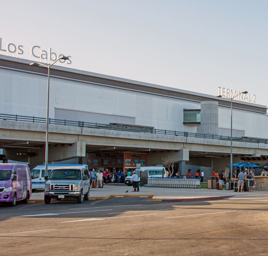 Los Cabos Airport shuttle transportation sitting outside of terminal 2.