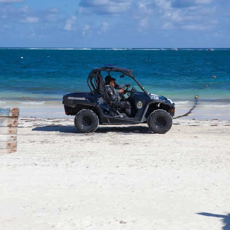 vehicle in sand with police officers