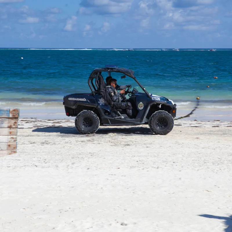 Police Ride in Four Wheeler at Beach