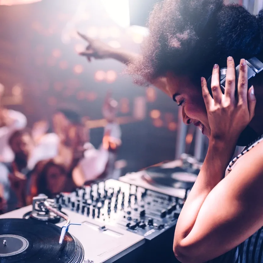 DJ playing music to a crowd in a nightclub