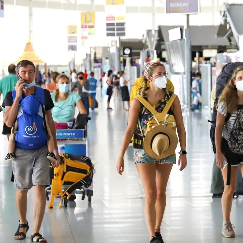 people wearing masks at busy airport
