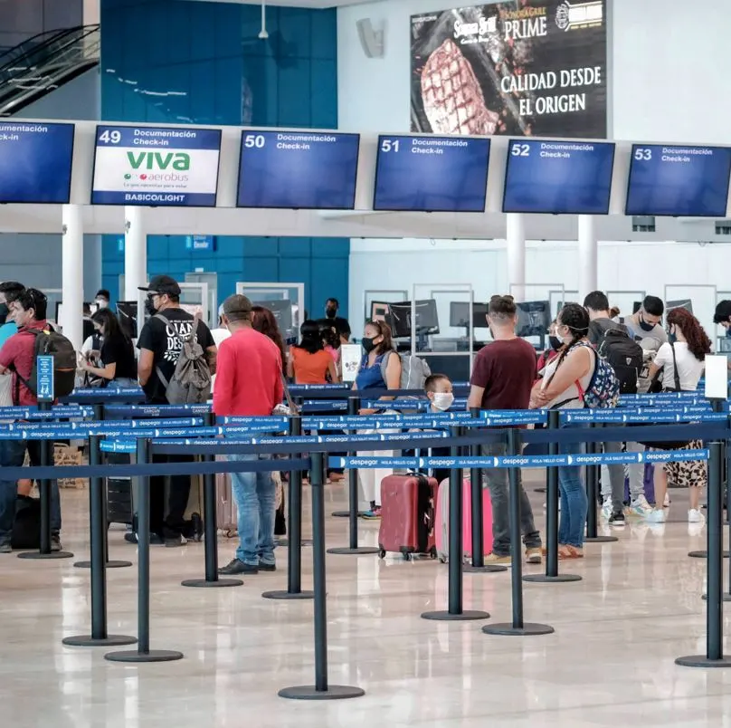 Tourists waiting in airport line in Mexico.
