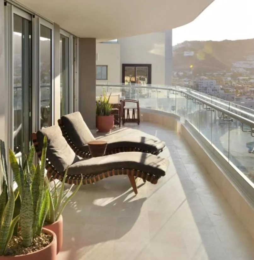 Lounge chairs on sunny balcony 