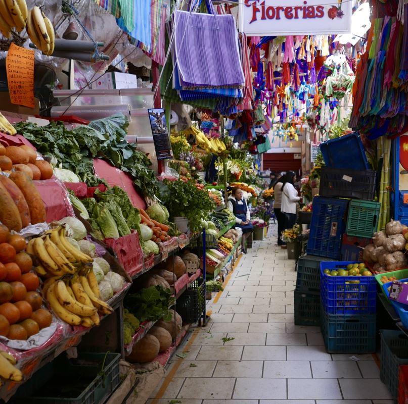 Fresh produce and other goods at a Mexican market.
