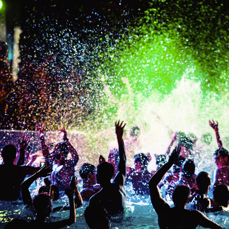 Nighttime pool party with neon lights