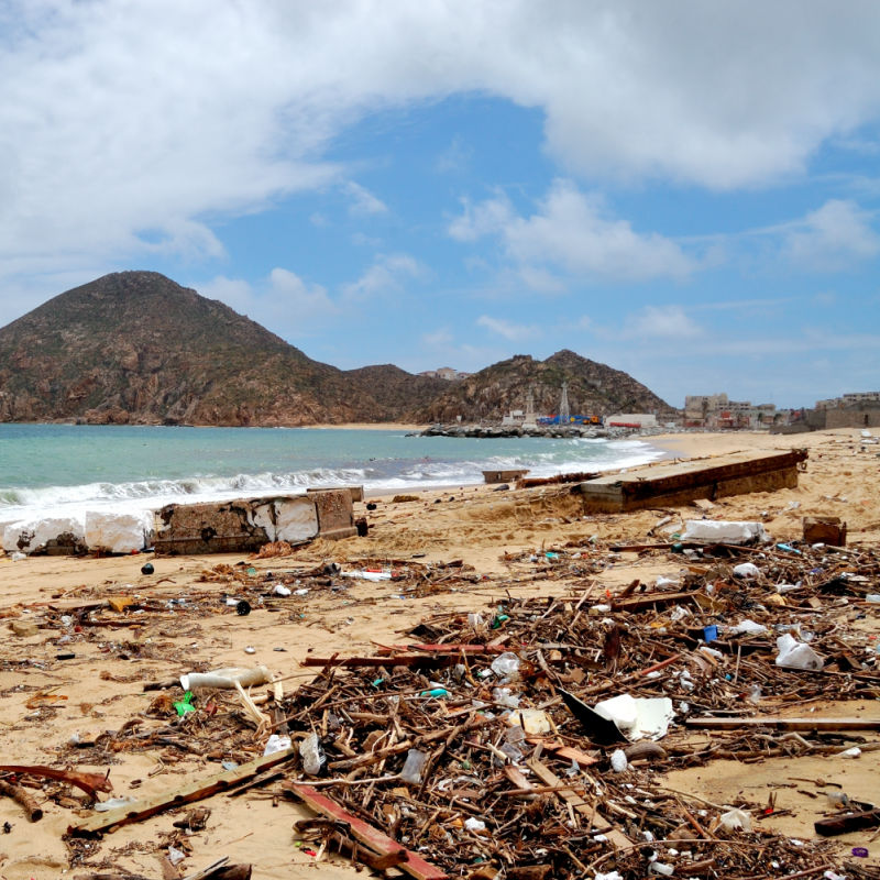 Trash and debris on a Los Cabos beach after a strong storm