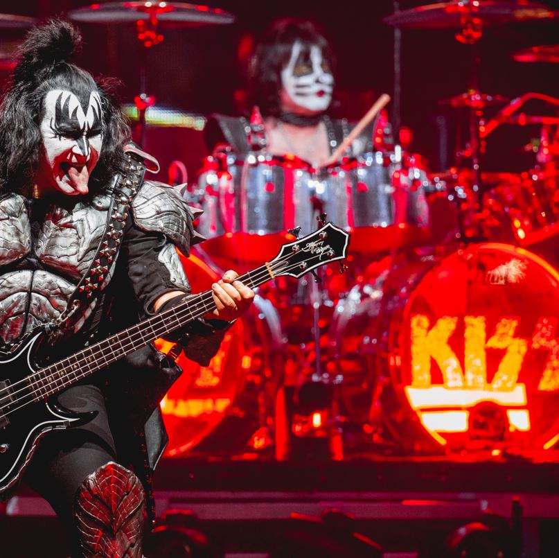 Kiss rock group performing with guitar and drums