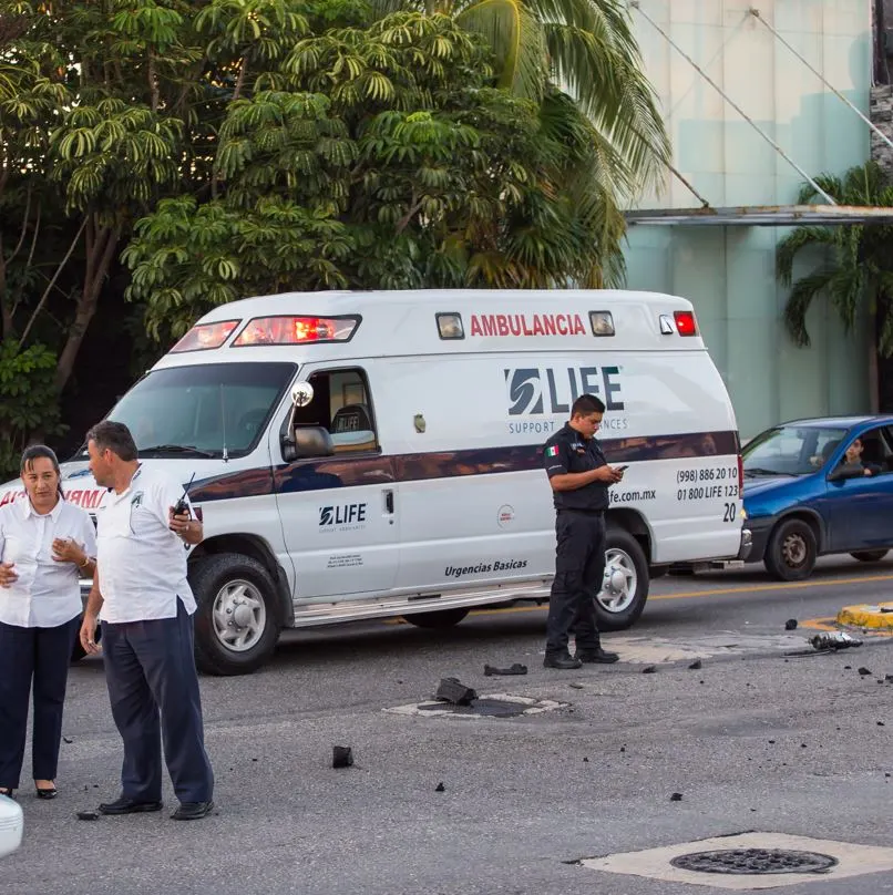 Traffic accident scene with debris, police, and abulance