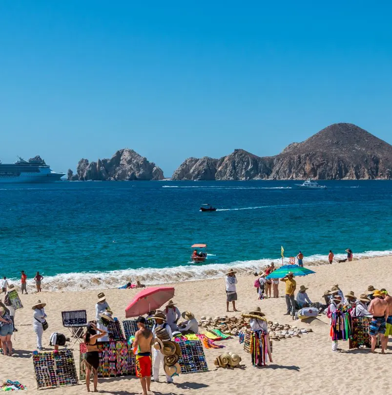 Vendors on the beach selling items on the sand