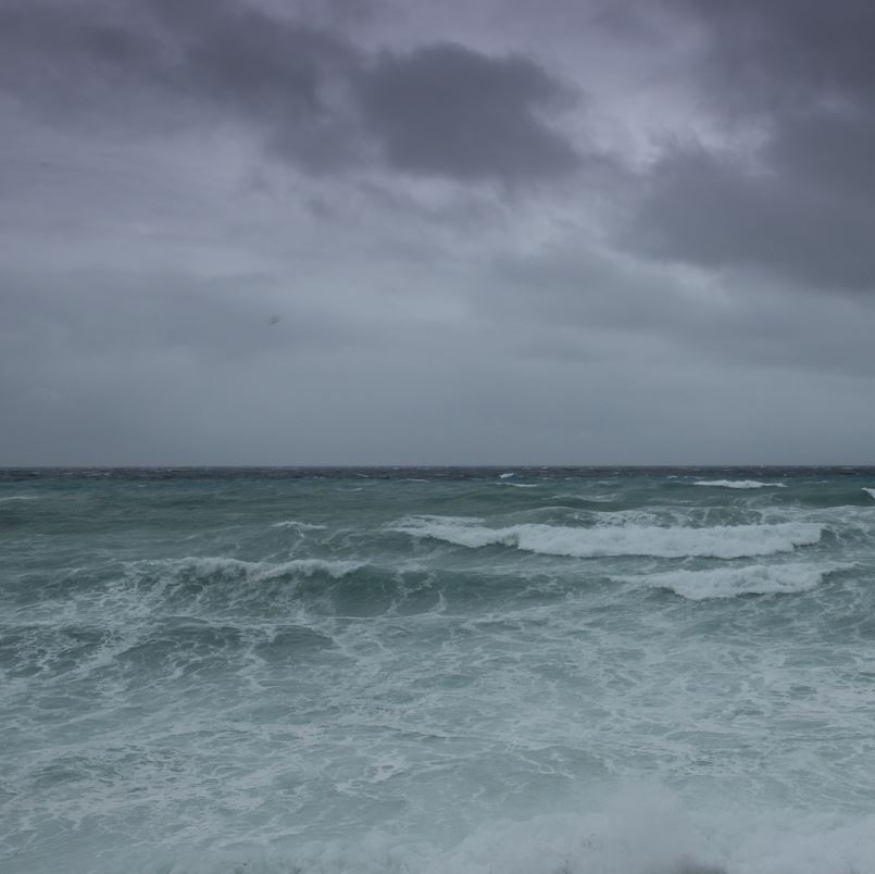 Waves in the ocean with gray skies