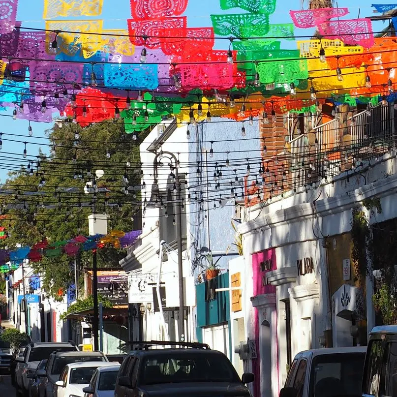 Cars parked along the street with colorful streamers