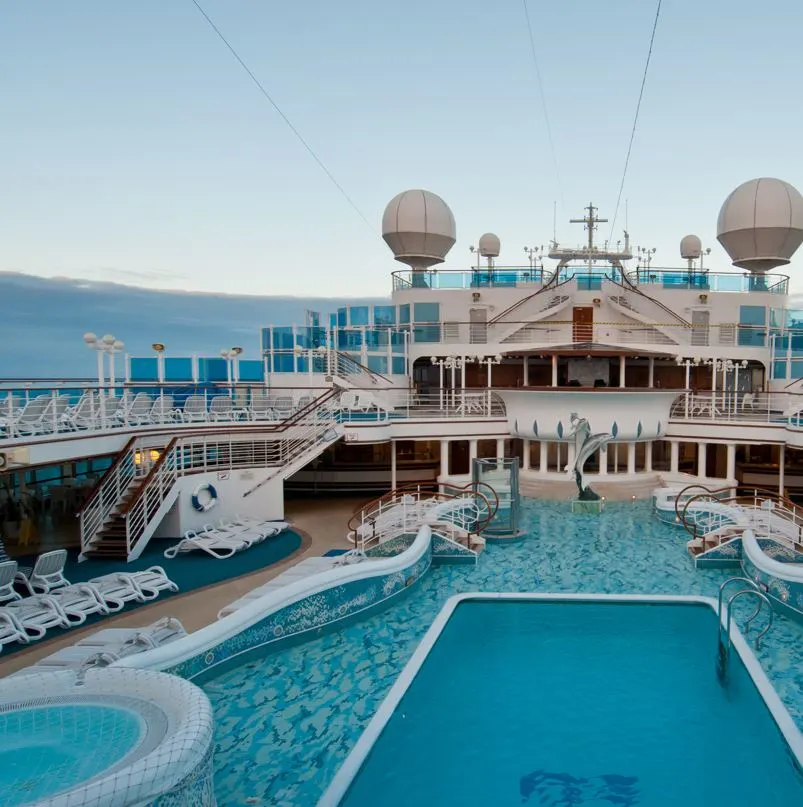 Large cruise ship deck with pool, hot tubs and lounge chairs