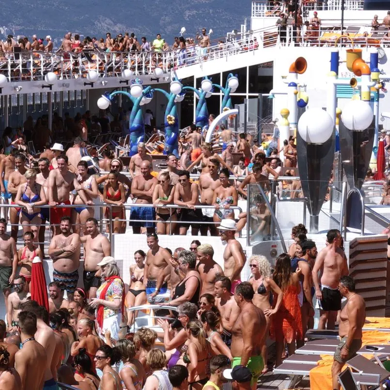 large crowd of people in a pool area