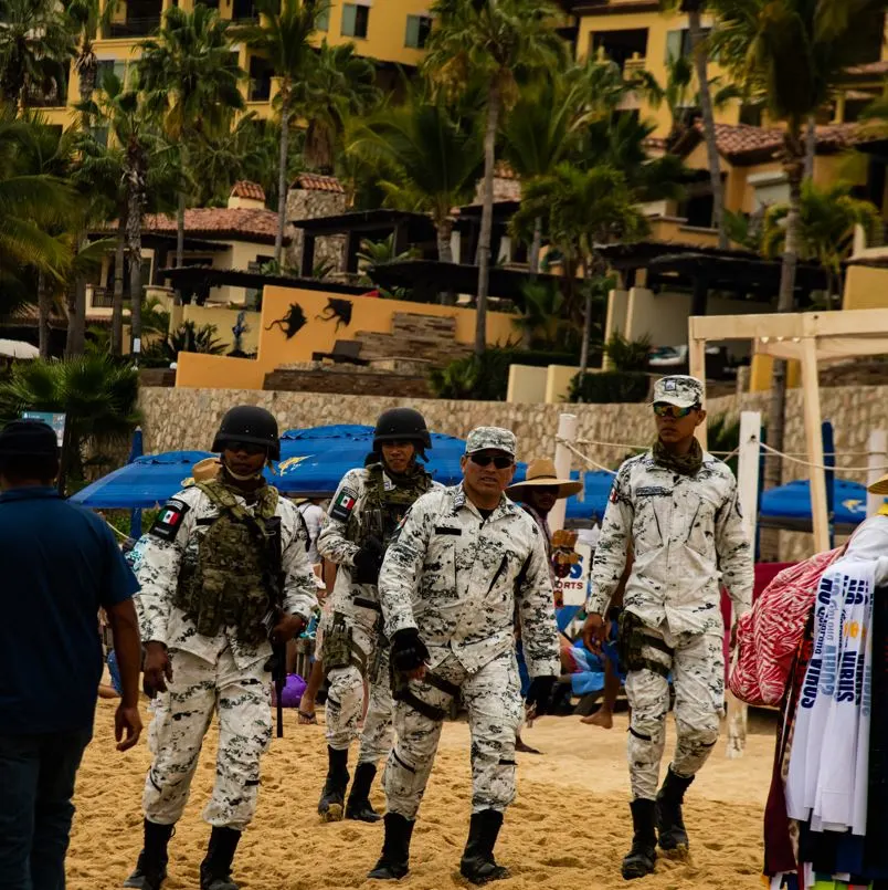 Mexico army members walking on the beach