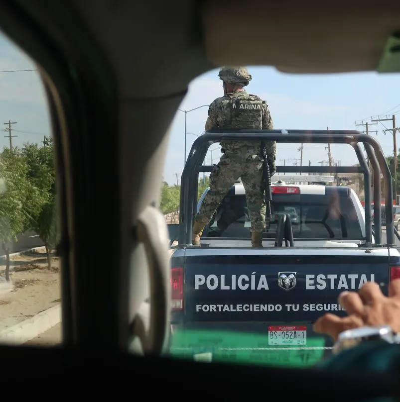 SJC police in the back of a truck on the streer