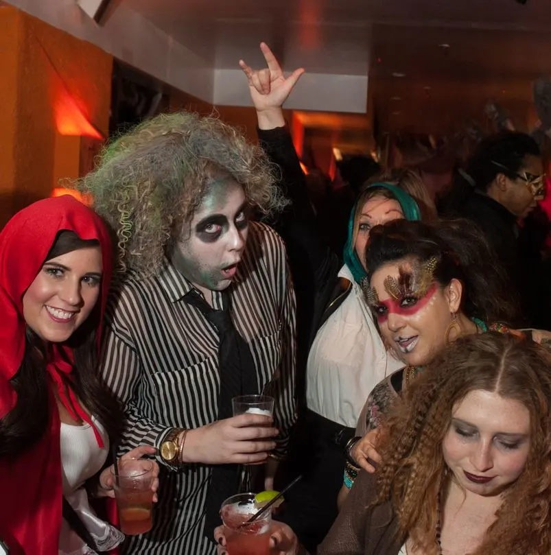 Friends posing in Halloween costumes