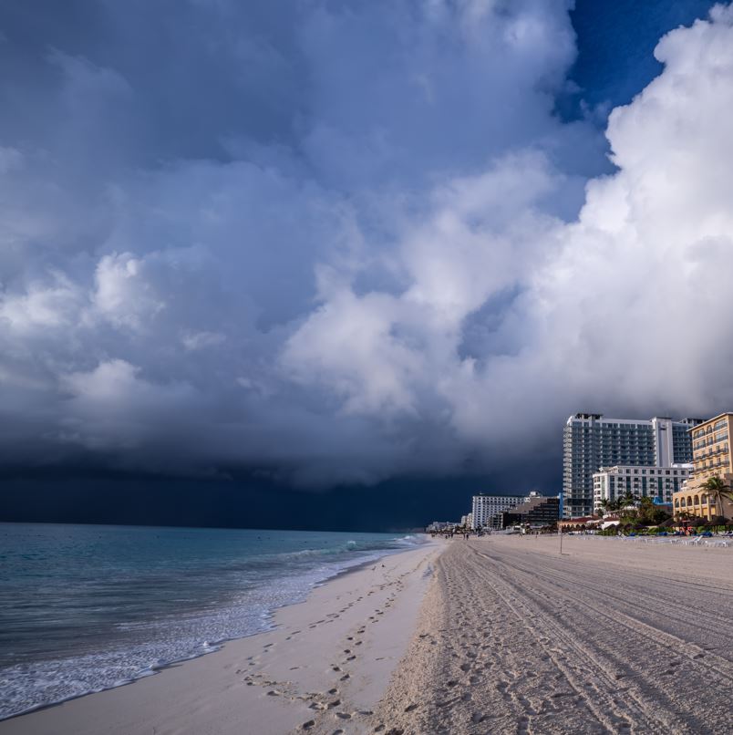 Resorts on the coastline with dark threatening clouds overhead