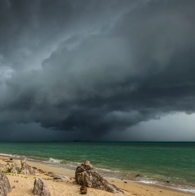 Dark storm clouds over the beach and ocean