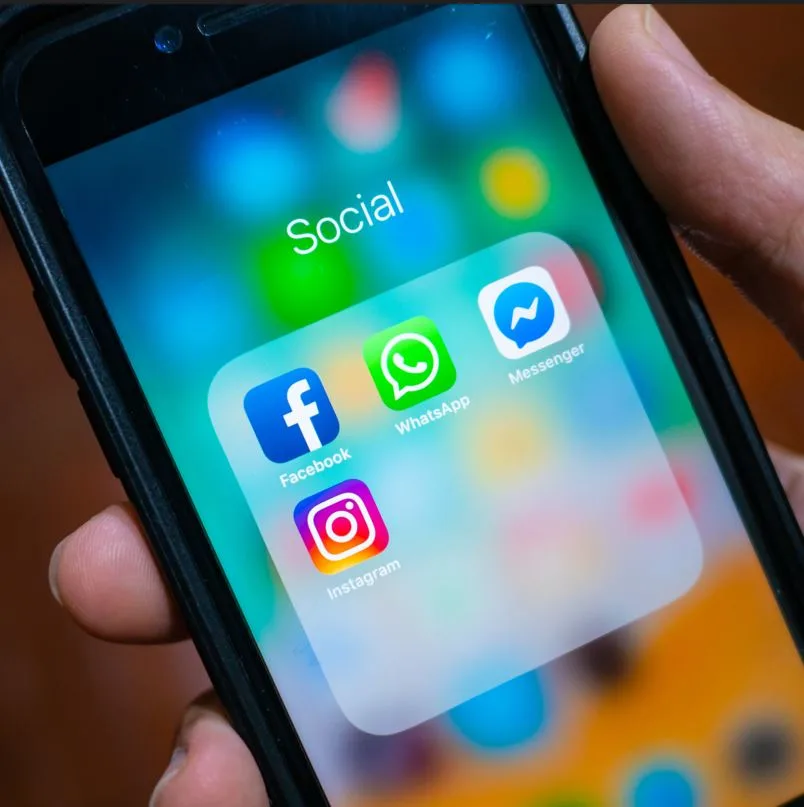 iPhone with social media icons like Facebook, WhatsApp and Messenger
