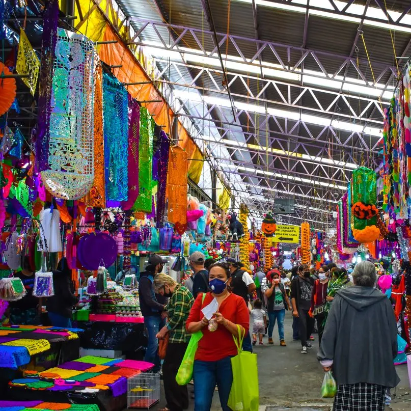 Mexican market with people walking with masks