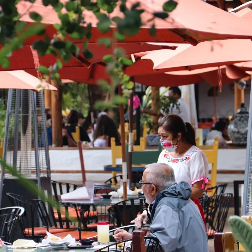 Waitress wearing mask in restaurant