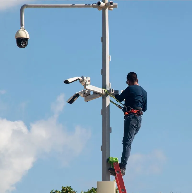 Installer putting up cameras