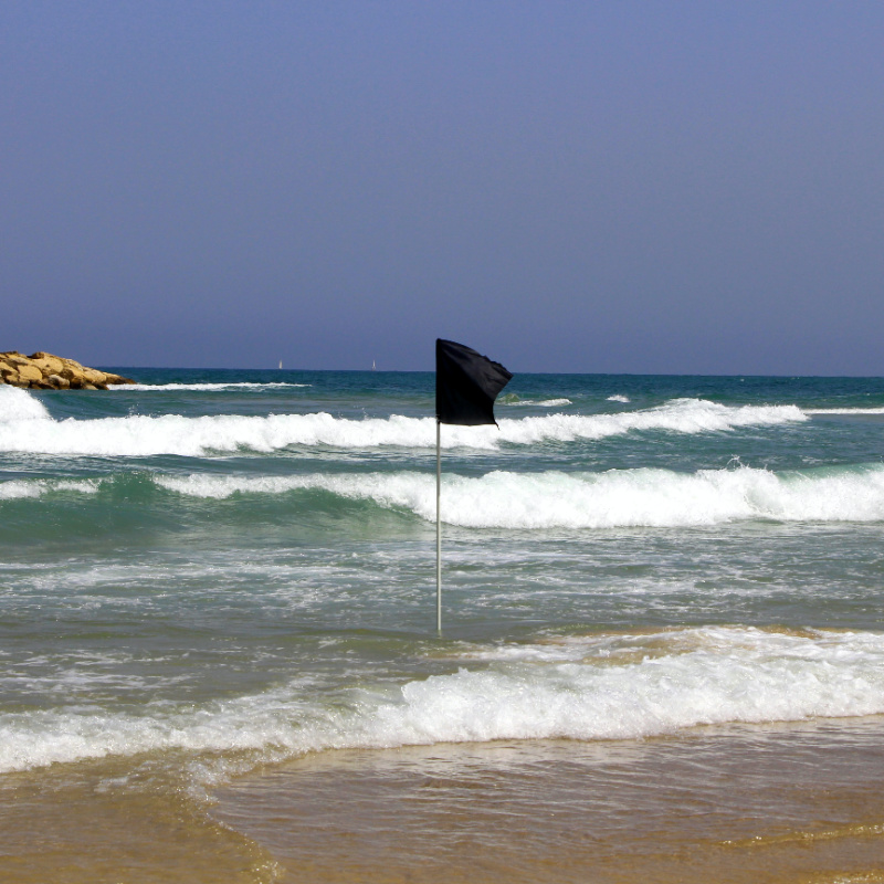 Black flag posted on a closed beach