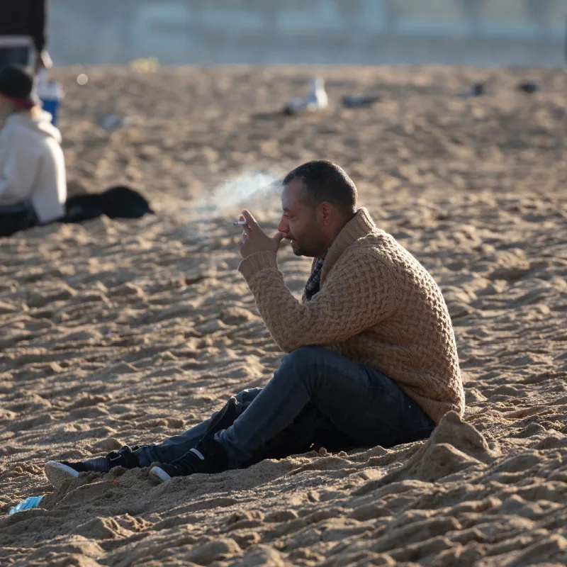 Man smoking on beach in Los Cabos