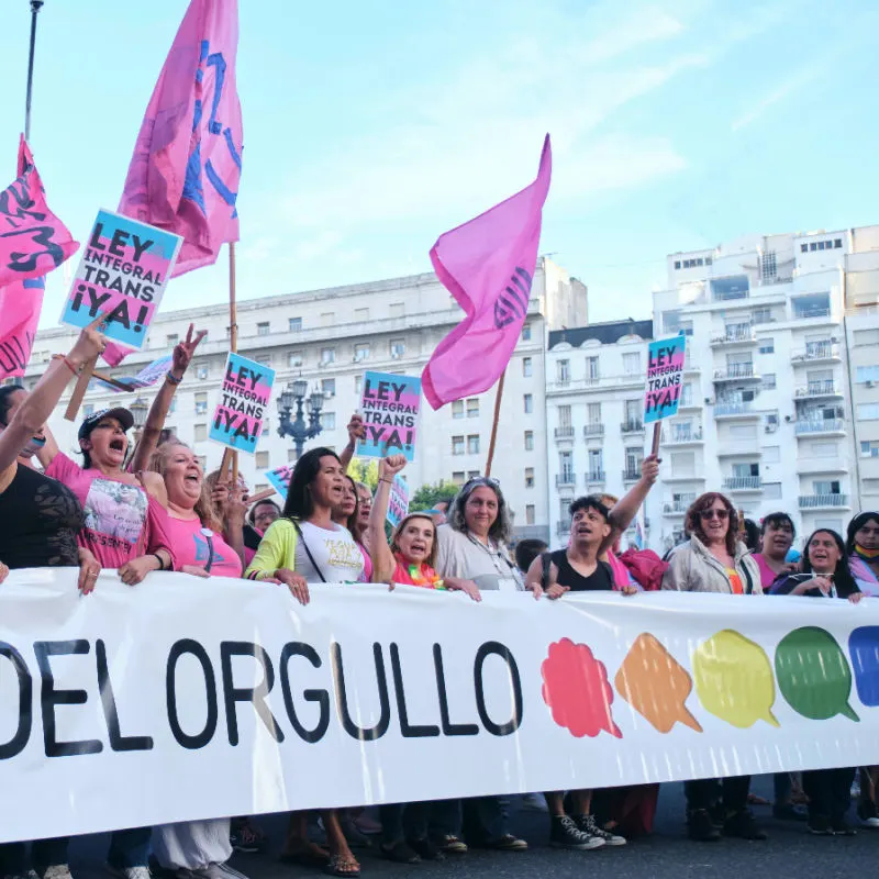 people holdin gup gay pride signs