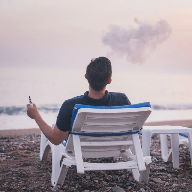 Man vaping on beach