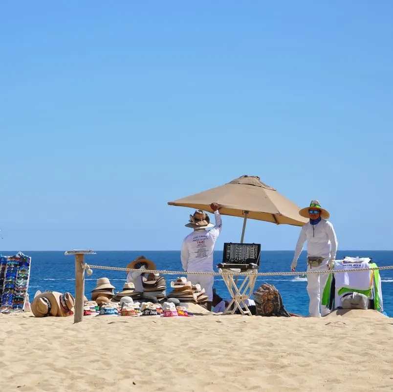 Beach vendors setting up displays in the sand