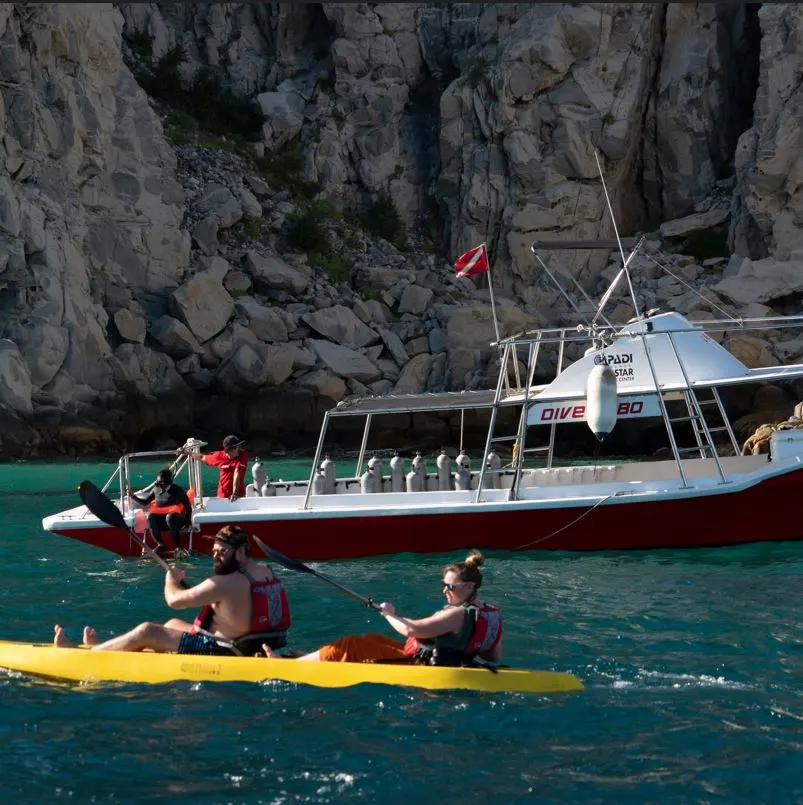 Couple rowing kayak close to Los Cabos Arch