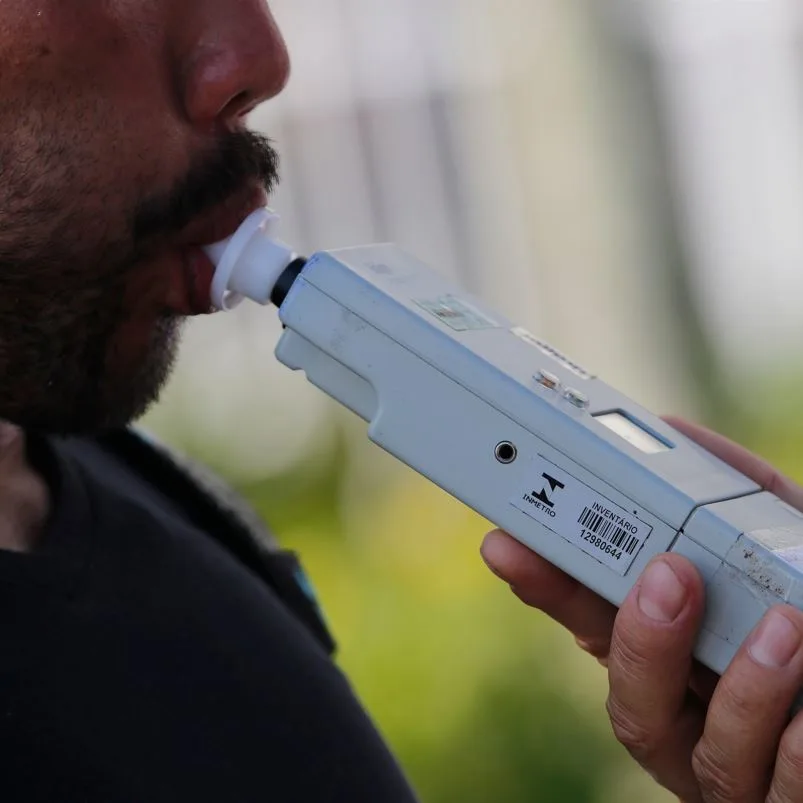 Man blowing into a breathalyzer