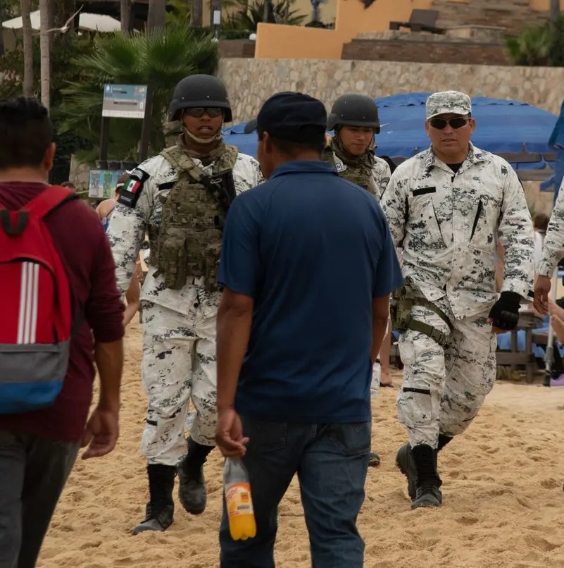 Mexican police walking on the beach