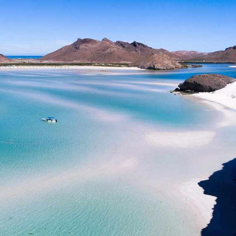 Secluded beach with blue waters and white sands