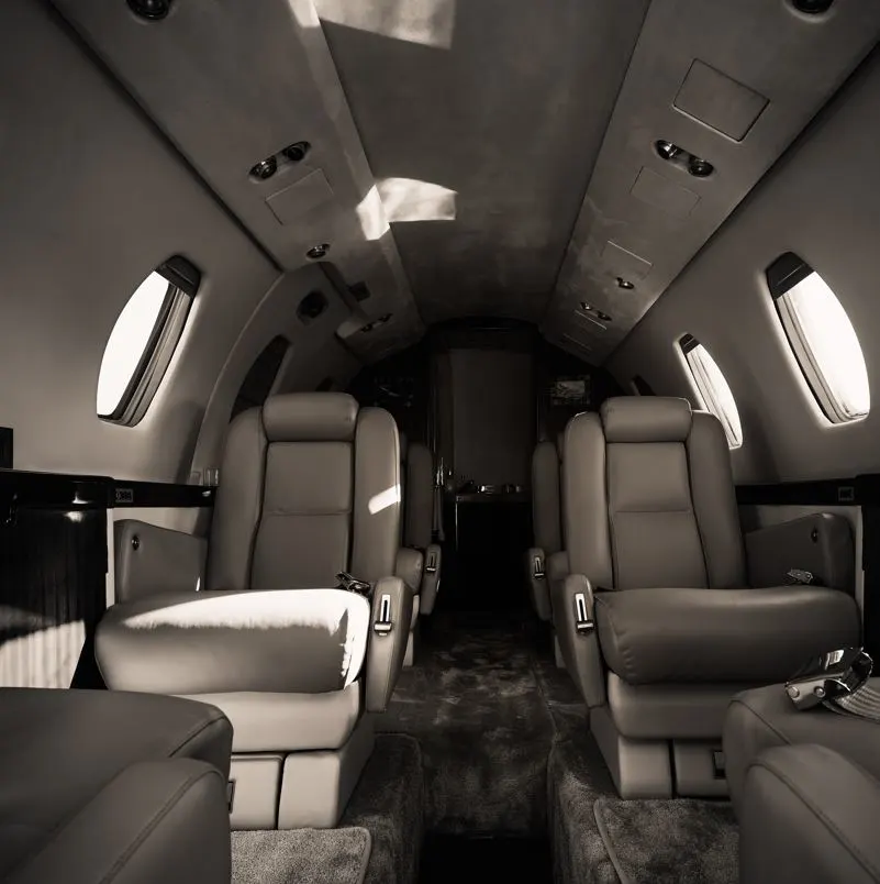 Private jet interior with leather seats and black accents