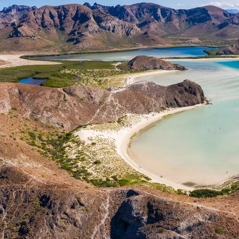 Aerial view of beach with rock formations and blue color