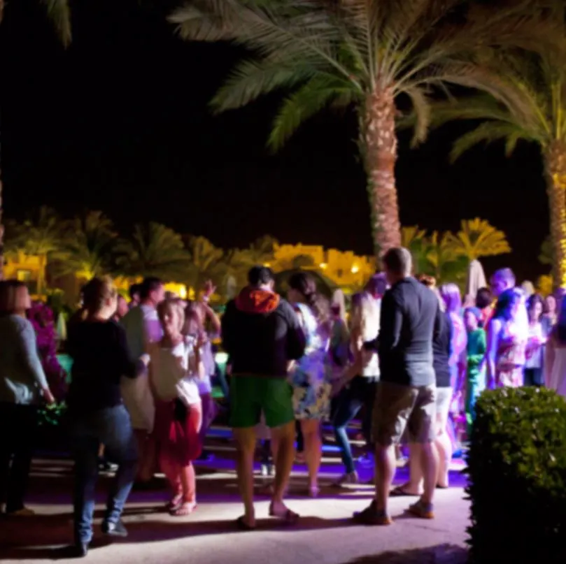 Large group dancing near the beach