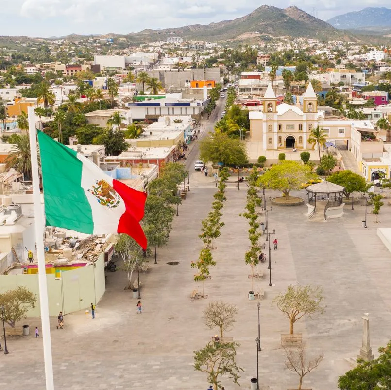 Aerial View of San Jose Del Cabo City Center with view of buildings and people and a backdrop of mountains.