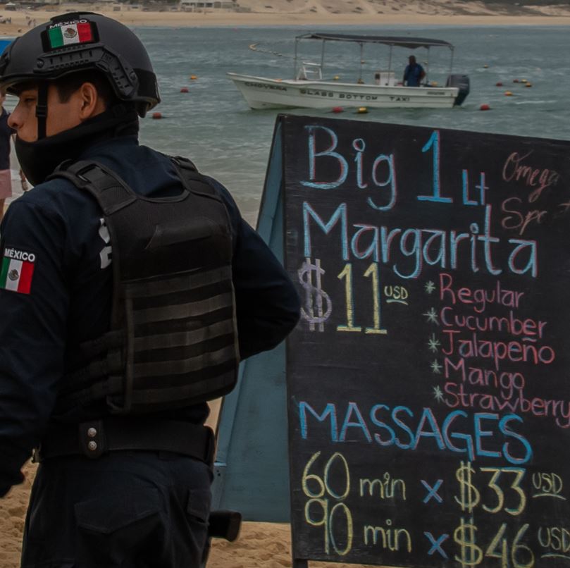 Police Officer Patrolling Beach Vendors