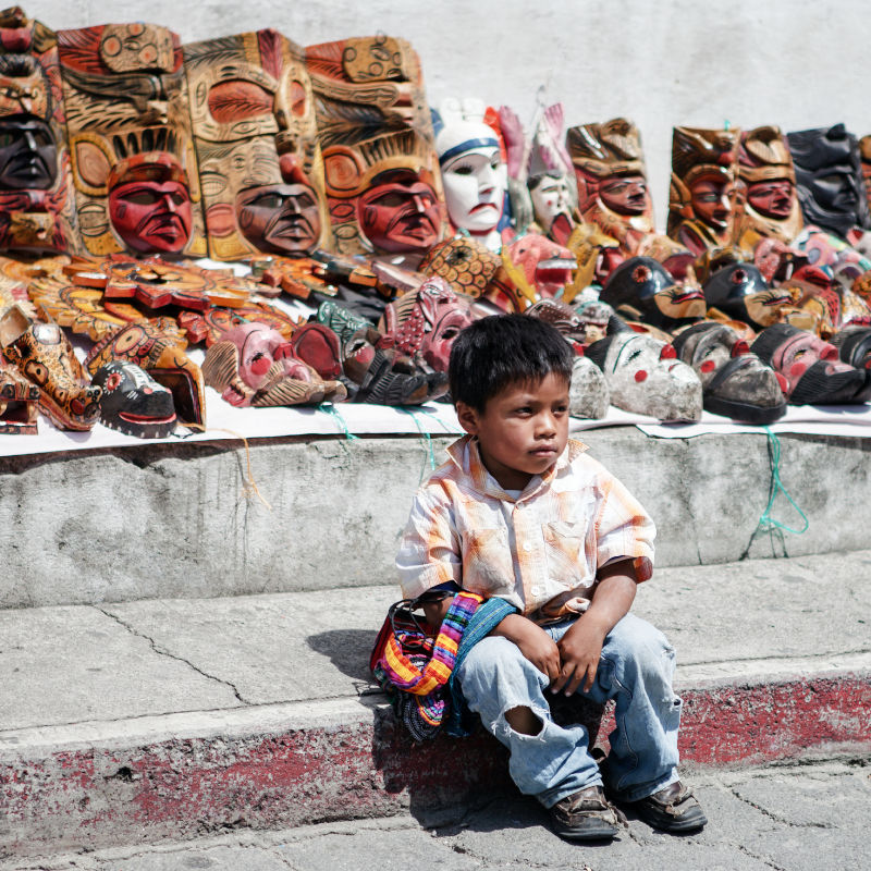 Young boy selling masks
