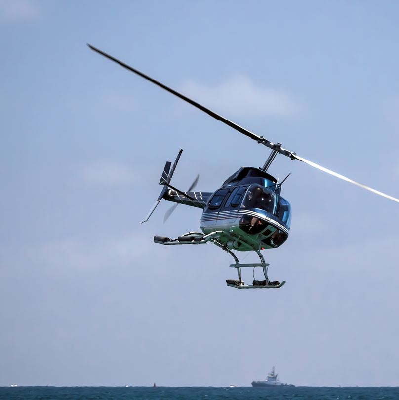 Helicopter flying over ocean