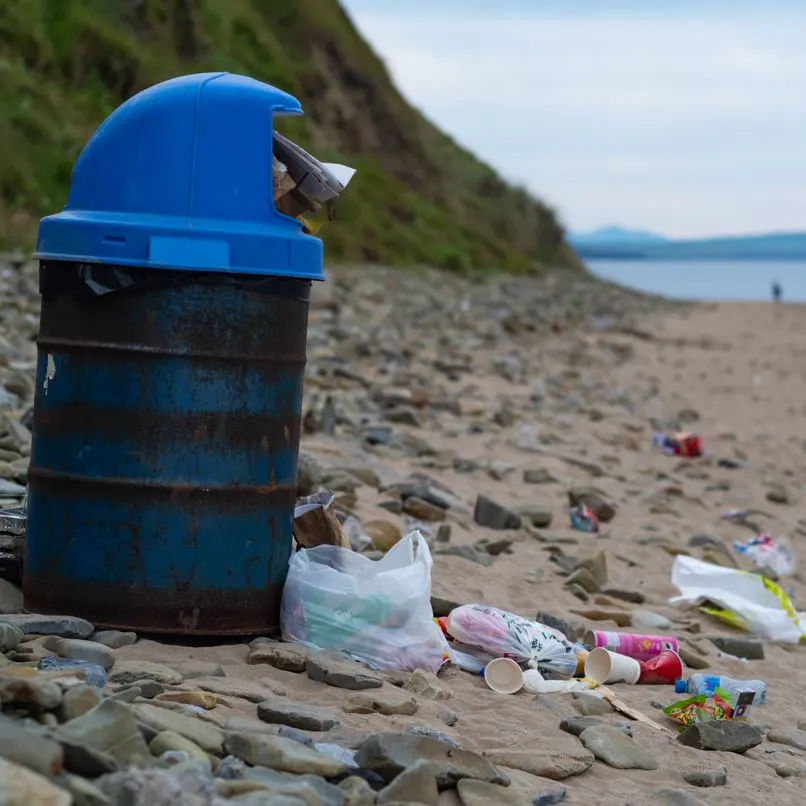 Trash overflowing beach trash can